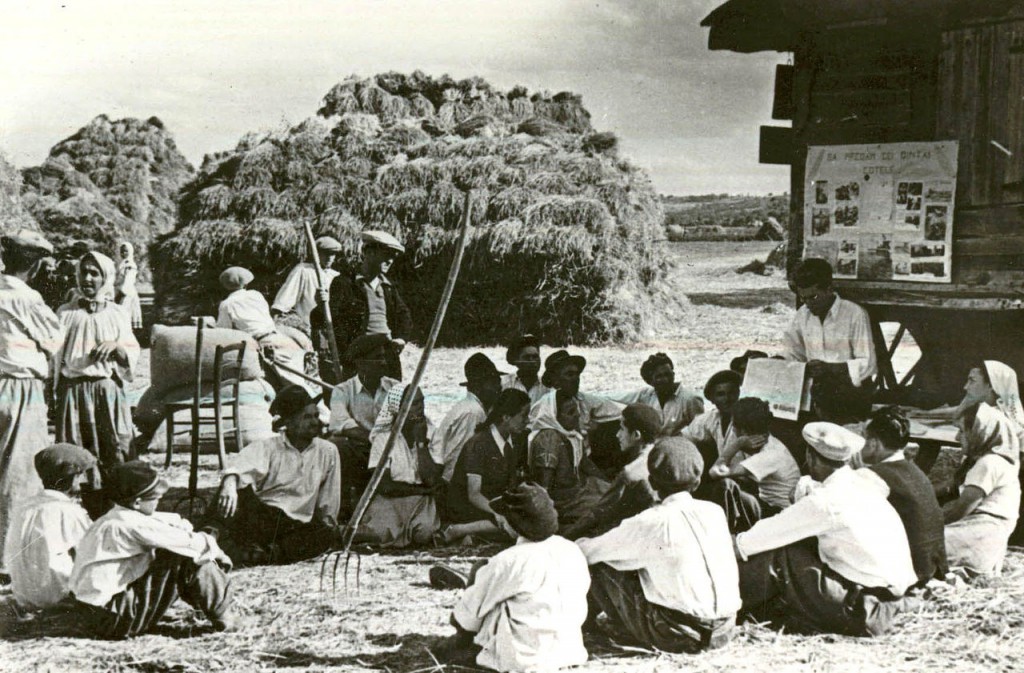 Peasants on a collective farm in Livezeni village, Arge? County being read a newspaper in 1950